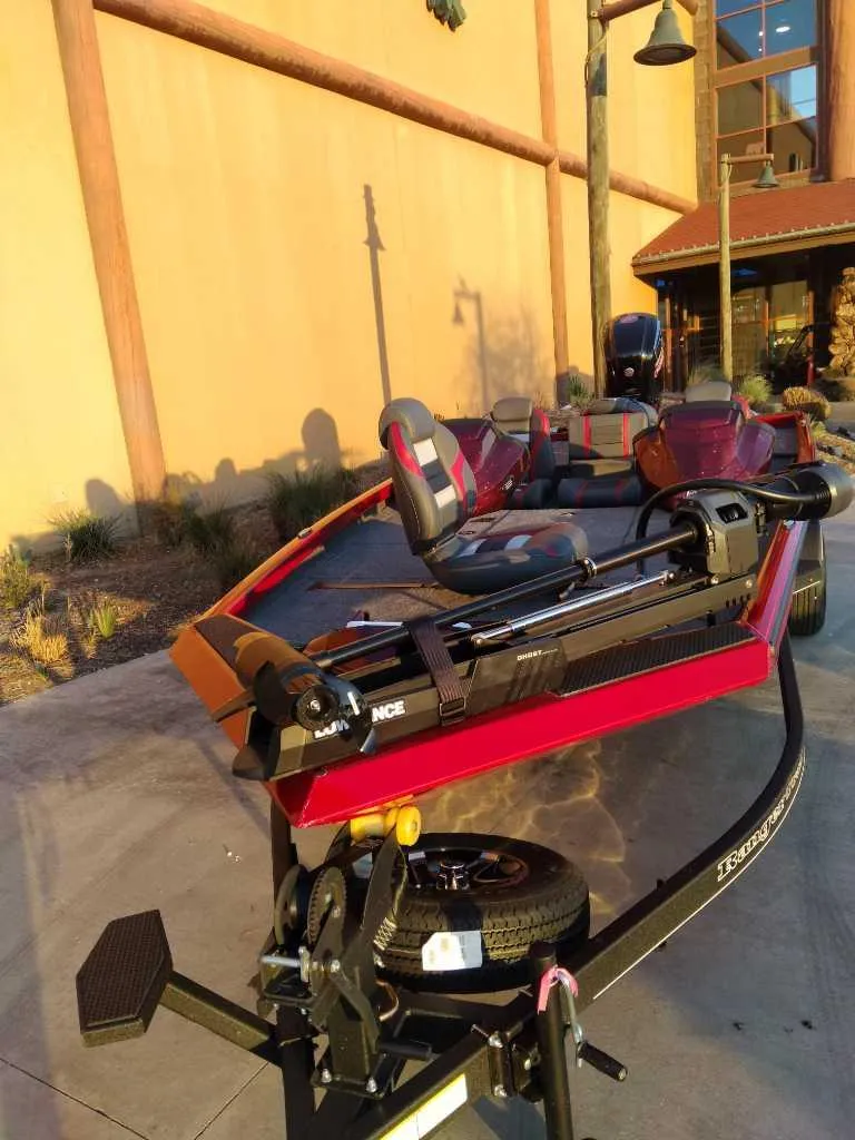 Slide: The Image of 2025 Ranger RT188P boat, red color, parked outdoors, showcasing sleek design and modern features. - 3