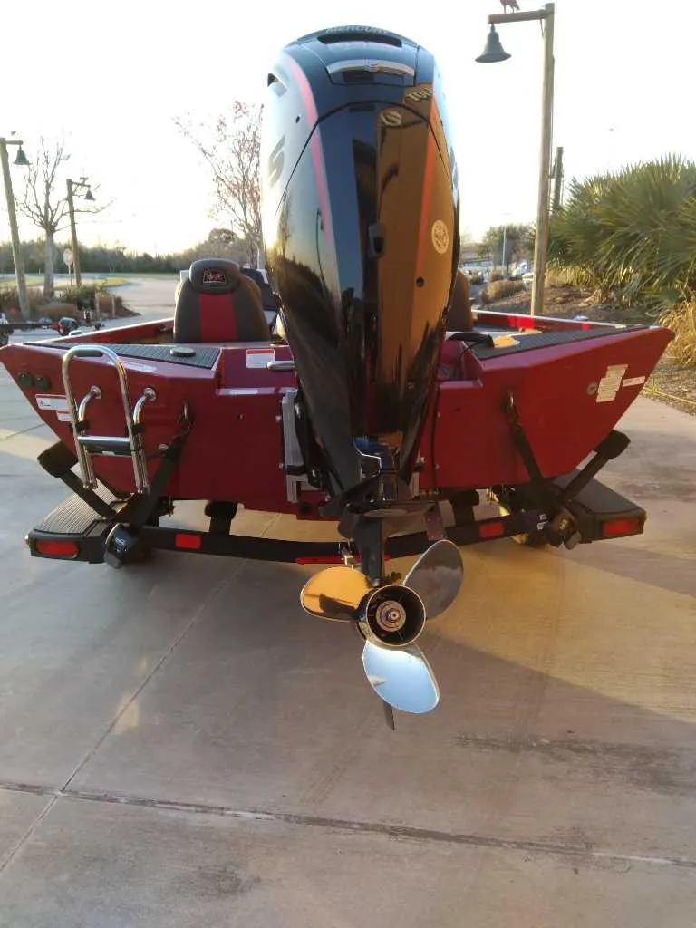 Slide: The Image of 2025 Ranger RT188P boat, rear view, red color, on a trailer, outdoor setting. - 6