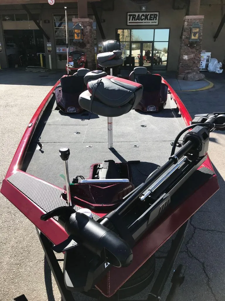 Slide: The Image of 2025 Ranger RT188P boat with red detailing, parked outside a Tracker store. - 3