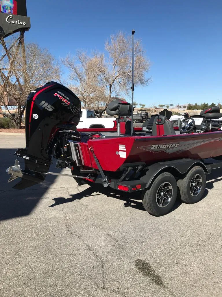 Slide: The Image of 2025 Ranger RT188P boat with powerful outboard motor, parked on a sunny day. - 4