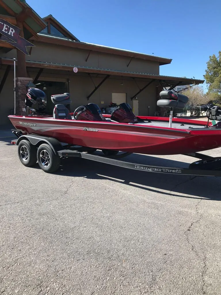 Slide: The Image of 2025 Ranger RT188P boat in red, parked on a trailer outside a building. - 6