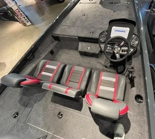 Slide: The Image of 2025 Ranger RT188P boat interior with gray and red seats, steering wheel, and Lowrance electronics. - 2