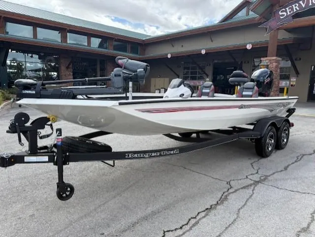 Slide: The Image of 2025 Ranger RT198P fishing boat on trailer, parked outside a building. - 0