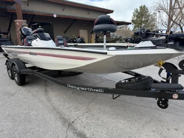 Slide: The Image of 2025 Ranger RT198P fishing boat on trailer, parked outdoors. - 1
