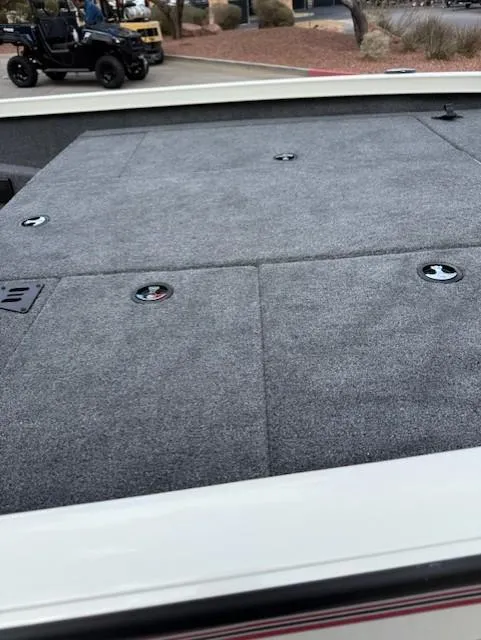 Slide: The Image of 2025 Ranger RT198P boat deck with gray carpet and storage compartments. - 10