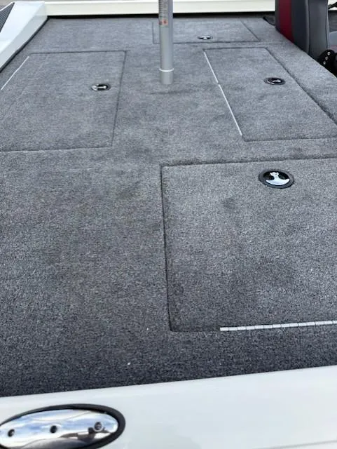 Slide: The Image of 2025 Ranger RT198P boat deck with storage compartments and carpeted surface. - 11