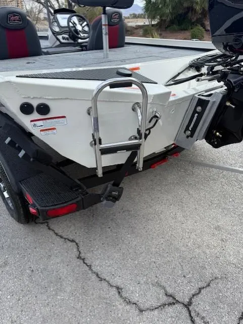 Slide: The Image of 2025 Ranger RT198P boat rear view with ladder and motor on trailer. - 12