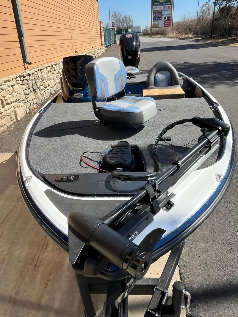 Slide: The Image of 2025 Nitro Z17 fishing boat with seating and trolling motor, parked outdoors. - 1