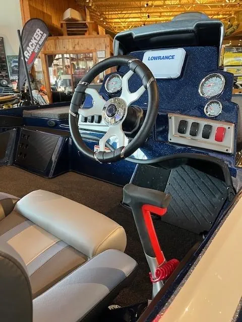 Slide: The Image of 2025 Nitro Z19 boat cockpit with steering wheel, gauges, and Lowrance electronics. - 4