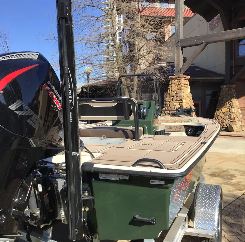 Slide: The Image of 2025 Mako 18 Pro Skiff Backwater Edition boat on trailer, outdoor setting. - 3