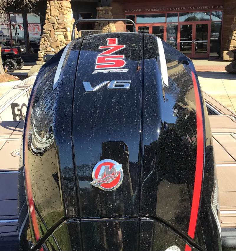 Slide: The Image of 2025 Mako 18 Pro Skiff Backwater Edition, 175 V6 engine detail, outdoors. - 4