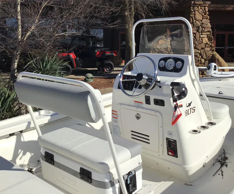 Slide: The Image of 2025 Mako 18 LTS boat interior with steering console and seating. - 2