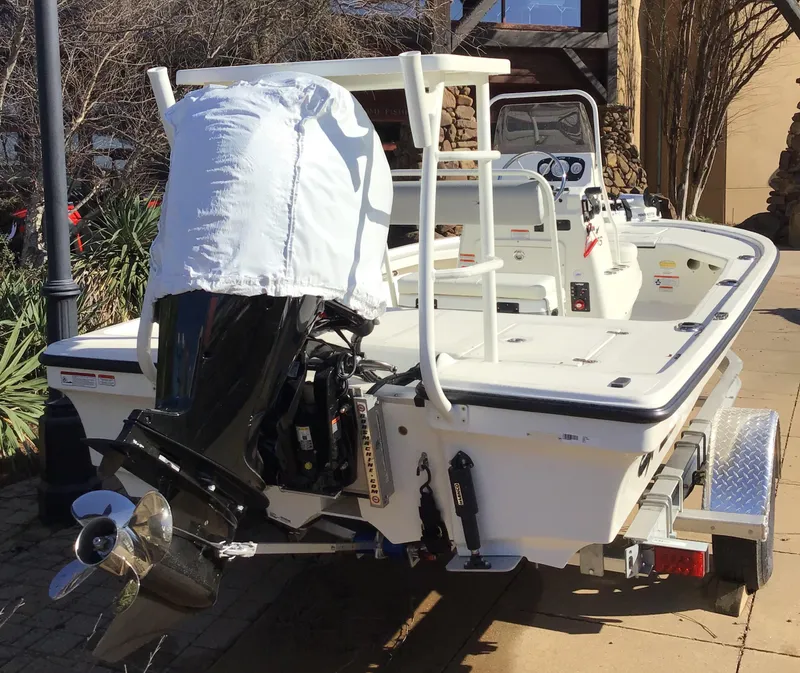 Slide: The Image of 2025 Mako 18 LTS boat on trailer, featuring covered outboard motor. - 3