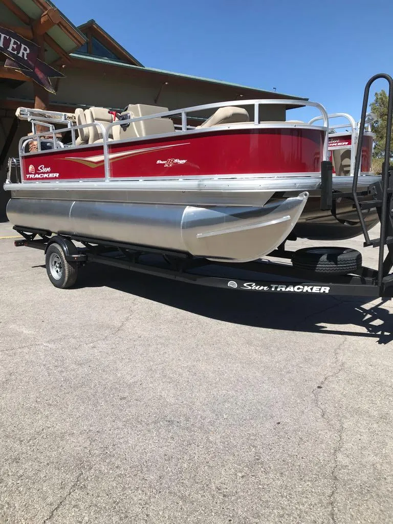 Slide: The Image of 2025 Sun Tracker Bass Buggy 18 DLX pontoon boat on trailer, red and silver design. - 6