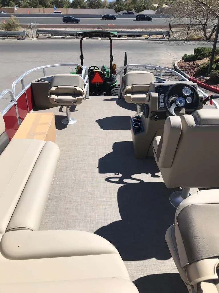 Slide: The Image of 2025 Sun Tracker Bass Buggy 18 DLX pontoon boat interior with beige seating. - 7