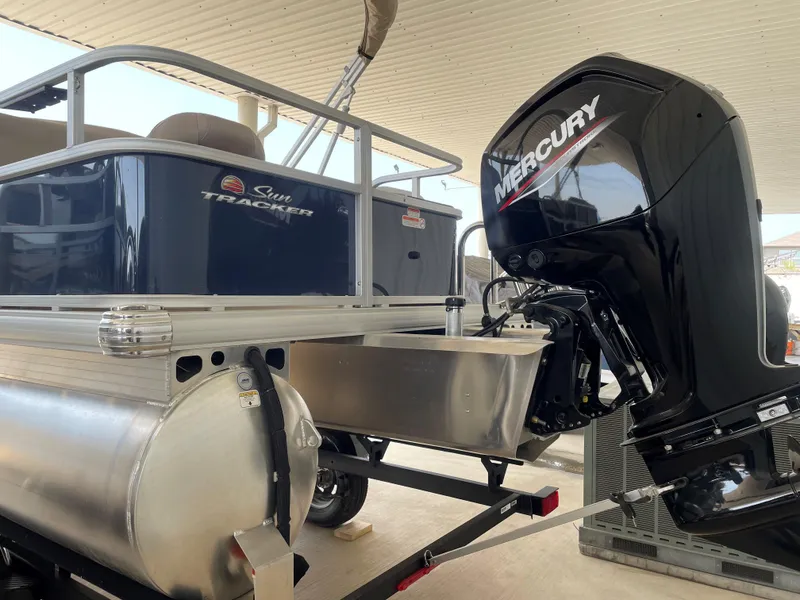 Slide: The Image of 2025 Sun Tracker Bass Buggy 18 DLX pontoon boat with Mercury outboard motor. - 2