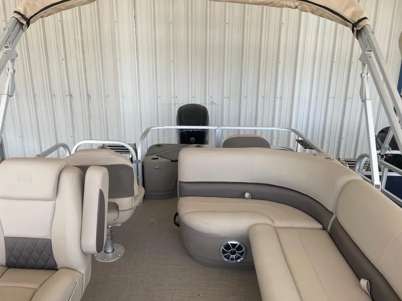 Slide: The Image of 2025 Sun Tracker Bass Buggy 18 DLX pontoon boat with beige seating and canopy. - 6