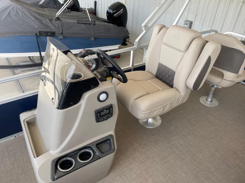 Slide: The Image of 2025 Sun Tracker Bass Buggy 18 DLX pontoon boat interior with steering console and seating. - 7