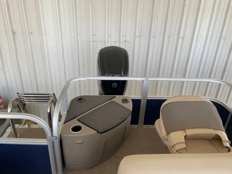 Slide: The Image of 2025 Sun Tracker Bass Buggy 18 DLX pontoon boat interior with seating and motor. - 8