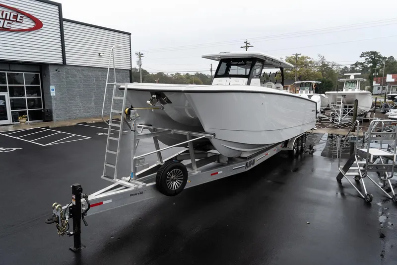 The Image of 2025 Twin Vee 400 GFX CC boat on trailer outside dealership. - 1