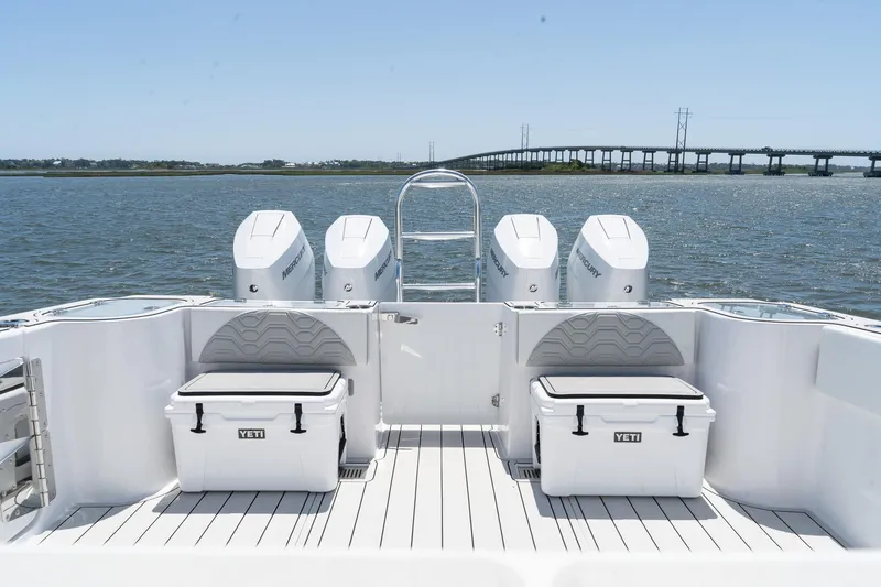 Slide: The Image of 2025 Twin Vee 400 GFX CC boat with four engines and Yeti coolers on deck. - 14