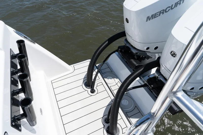 Slide: The Image of Twin Vee 400 GFX CC 2025 boat with Mercury outboard engines on water. - 18