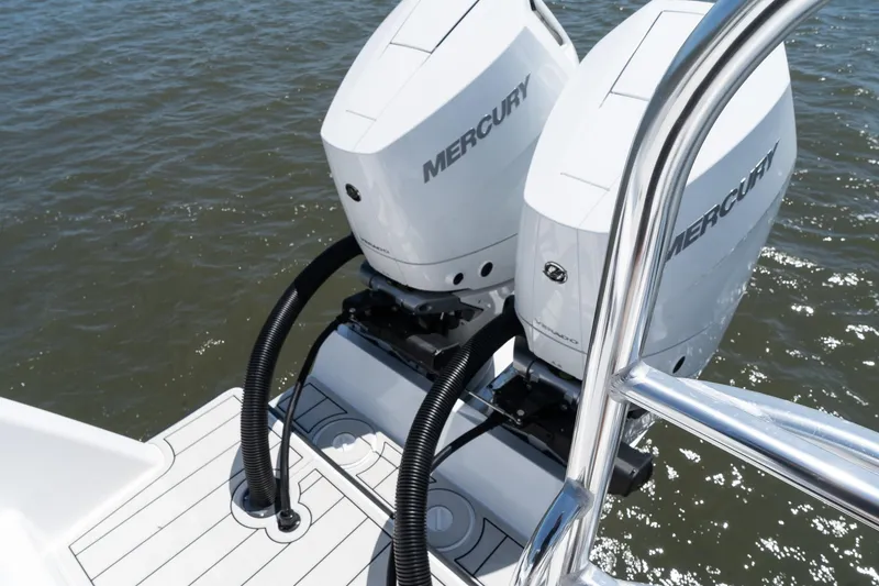 Slide: The Image of Twin Vee 400 GFX CC 2025 boat with dual Mercury outboard engines on water. - 19
