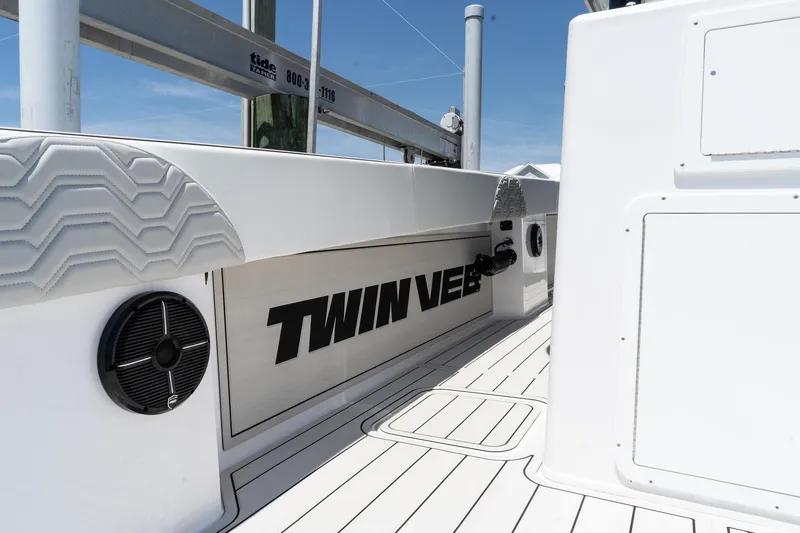 Slide: The Image of 2025 Twin Vee 400 GFX CC boat deck with branding and speaker detail. - 24