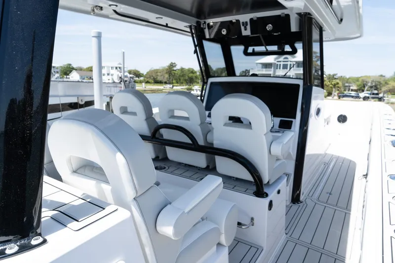 Slide: The Image of 2025 Twin Vee 400 GFX CC boat interior with modern seating and control panel. - 25