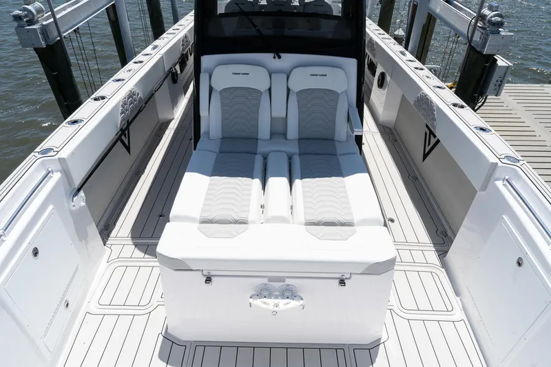 Slide: The Image of 2025 Twin Vee 400 GFX CC boat interior with white seating and sleek design. - 38