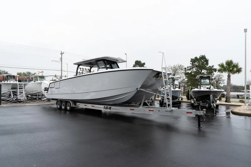 Slide: The Image of 2025 Twin Vee 400 GFX CC boat on trailer in parking lot. - 4