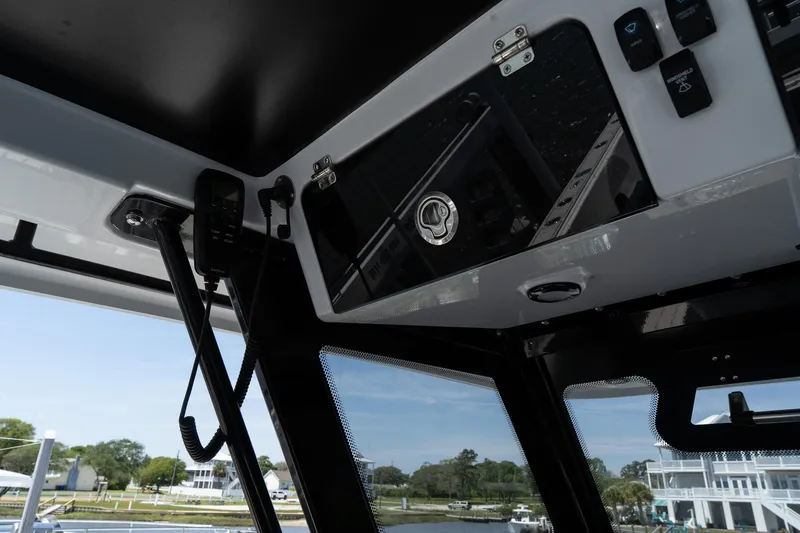 Slide: The Image of Interior view of 2025 Twin Vee 400 GFX CC boat, showcasing control panel and windows. - 45