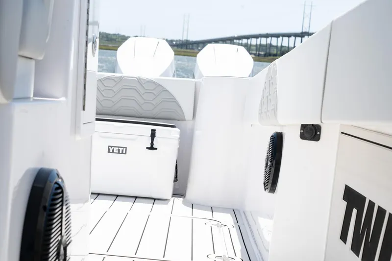 Slide: The Image of 2025 Twin Vee 400 GFX CC boat interior with Yeti cooler and scenic bridge view. - 48