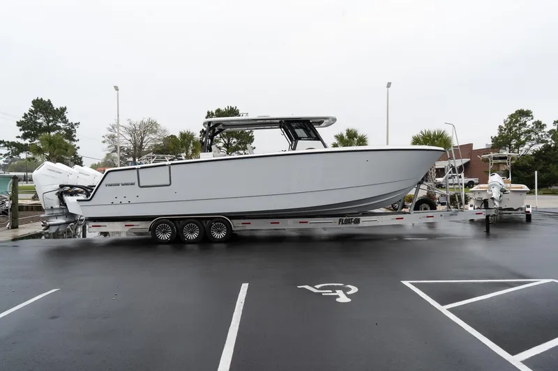 Slide: The Image of 2025 Twin Vee 400 GFX CC boat on trailer in parking lot. - 5