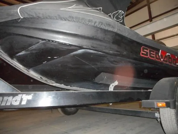 Slide: The Image of 2007 Sea-Doo RXT 215 jet ski on trailer, partially covered, in storage. - 3