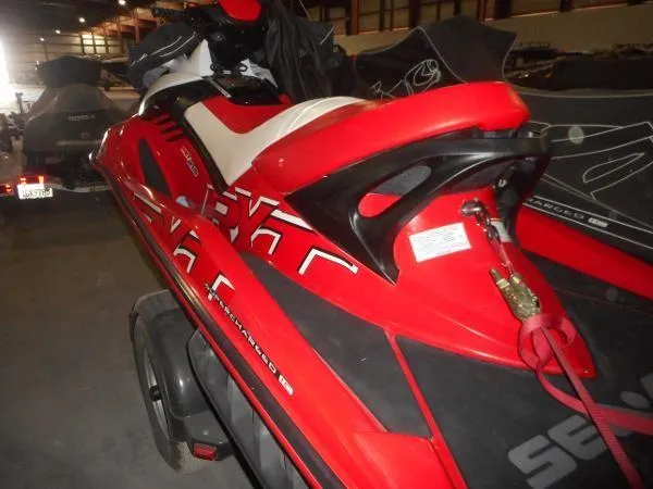 Slide: The Image of 2007 Sea-Doo RXT 215 jet ski in red, parked indoors. - 5