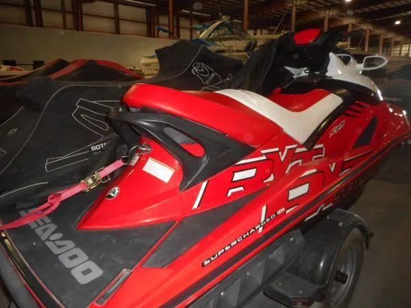 Slide: The Image of 2007 Sea-Doo RXT 215 jet ski in storage, red and white design. - 6