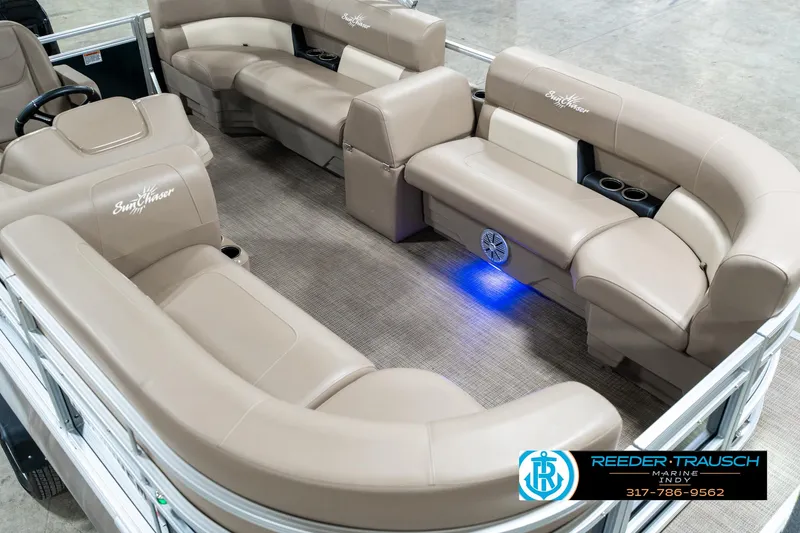 Slide: The Image of 2024 SunChaser 16 Vista pontoon boat interior with beige seating and blue LED lighting. - 13