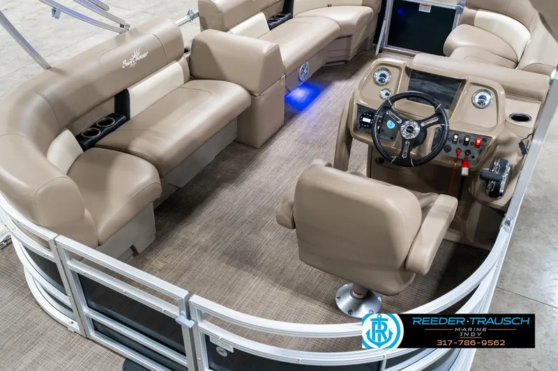 Slide: The Image of 2024 SunChaser 16 Vista pontoon boat interior with beige seating and modern dashboard. - 14