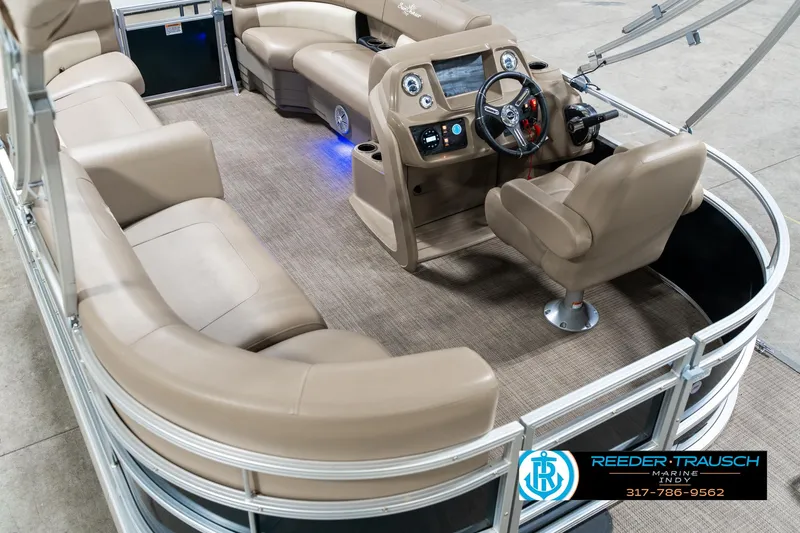 Slide: The Image of 2024 SunChaser 16 Vista pontoon boat interior with beige seating and modern dashboard. - 15
