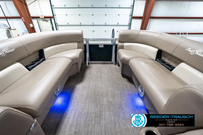 Slide: The Image of 2024 SunChaser 16 Vista pontoon boat interior with beige seating and blue LED lighting. - 20