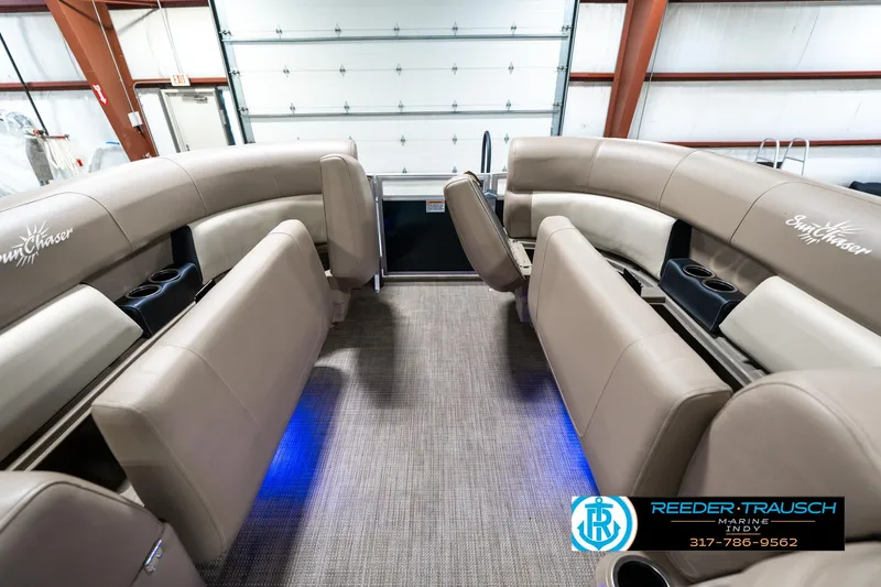 Slide: The Image of 2024 SunChaser 16 Vista boat interior with beige seating and blue accent lighting. - 21
