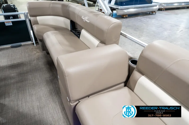 Slide: The Image of 2024 SunChaser 16 Vista pontoon boat interior with beige seating and cup holders. - 22