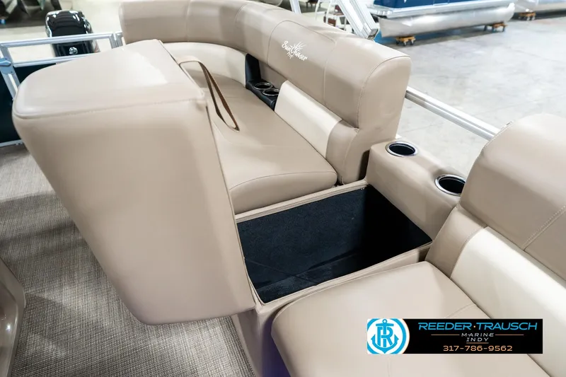 Slide: The Image of 2024 SunChaser 16 Vista boat interior with beige seating and storage compartment. - 23