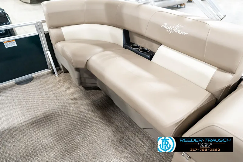 Slide: The Image of 2024 SunChaser 16 Vista boat interior with beige seating and cup holders. - 24