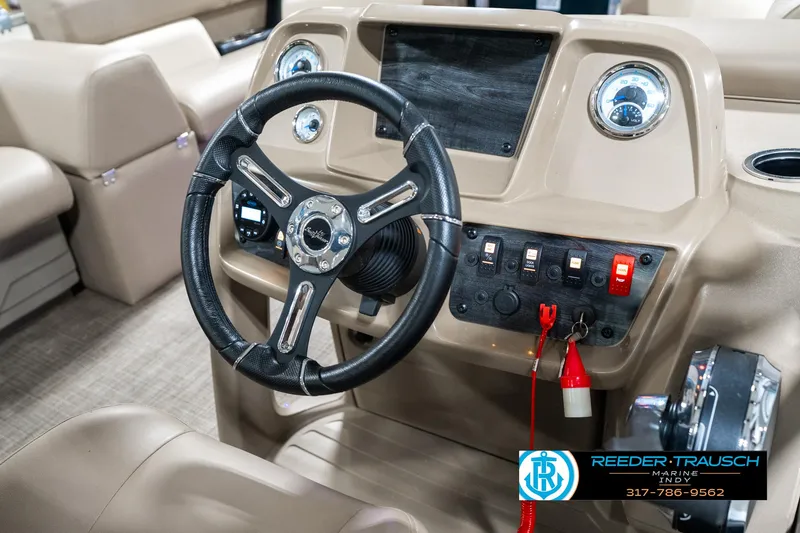 Slide: The Image of 2024 SunChaser 16 Vista boat dashboard with steering wheel and control panel. - 26