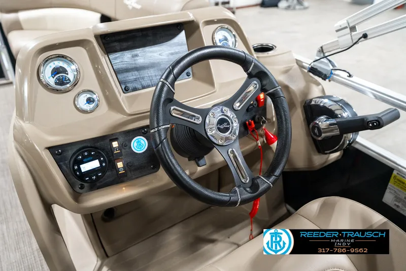 Slide: The Image of 2024 SunChaser 16 Vista boat dashboard with steering wheel and control panel. - 27