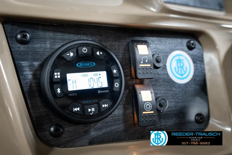 Slide: The Image of 2024 SunChaser 16 Vista dashboard with Jensen audio system and control switches. - 29