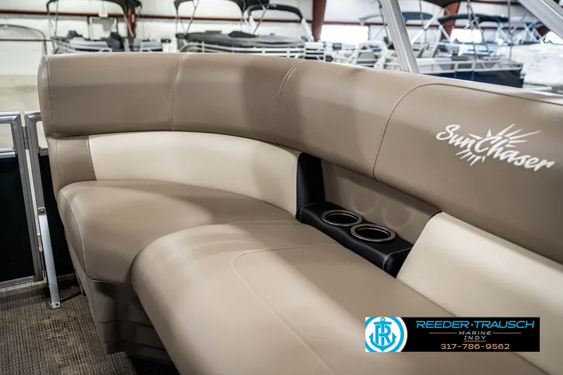 Slide: The Image of 2024 SunChaser 16 Vista boat interior with beige seating and cup holders. - 35