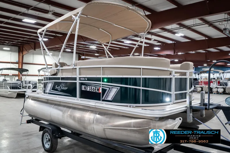 Slide: The Image of 2024 SunChaser 16 Vista pontoon boat on trailer in indoor showroom. - 6